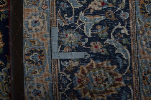 Backside of handmade 2000s Kashan rug showing knot structure and weave density