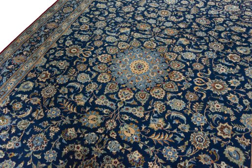 Backside of handmade 2000s Kashan rug showing knot structure and weave density