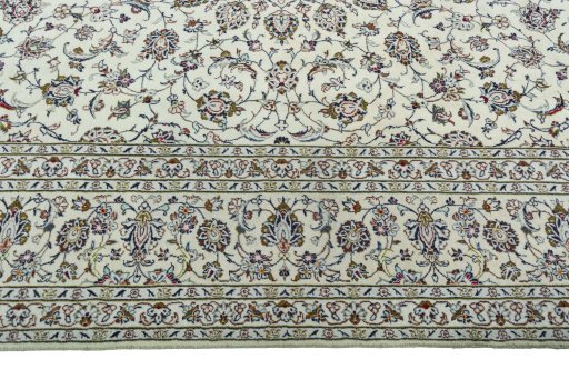 Corner detail of 2000s Kashan rug showing border pattern and Wool pile