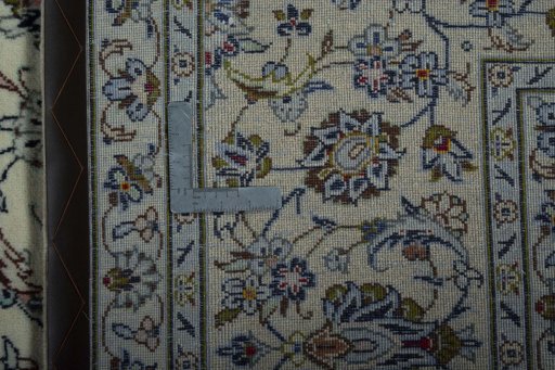 Backside of handmade 2000s Kashan rug showing knot structure and weave density