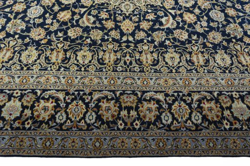 Corner detail of 2000s Kashan rug showing border pattern and Wool pile