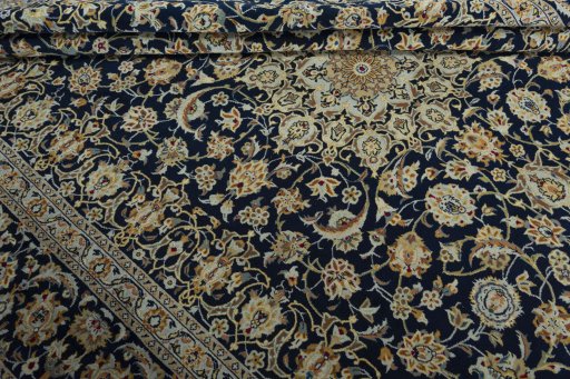 Close-up detail of 2000s Kashan rug from Iran / Persia showing Wool weave