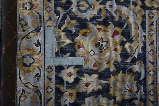 Backside of handmade 2000s Kashan rug showing knot structure and weave density