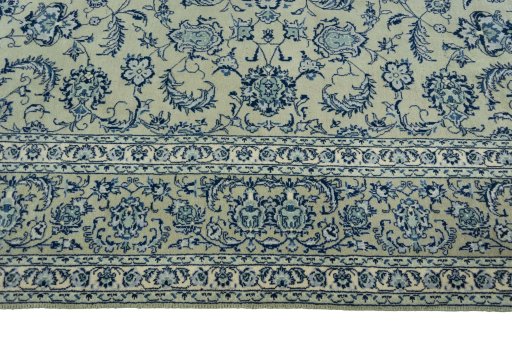 Corner detail of 2000s Kashan rug showing border pattern and Wool pile