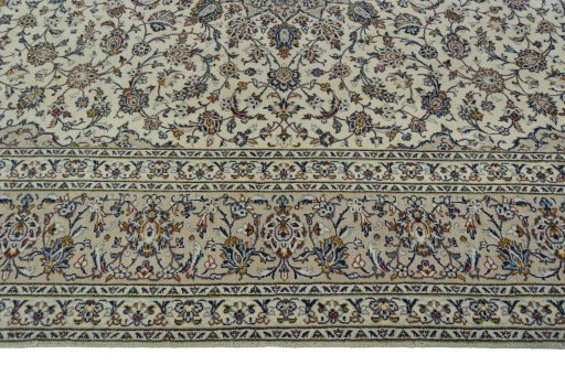 Corner detail of 2000s Kashan rug showing border pattern and Wool pile