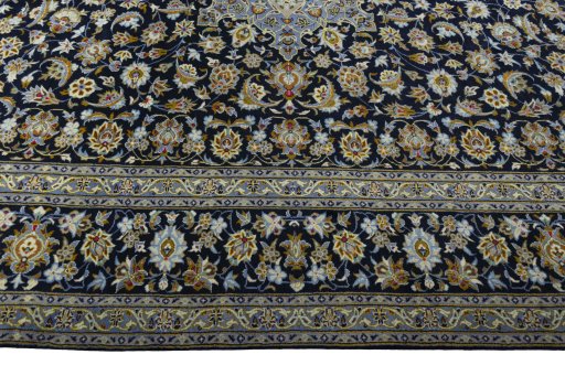 Corner detail of 2000s Kashan rug showing border pattern and Wool pile