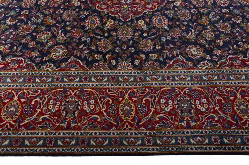 Corner detail of 2000s Kashan rug showing border pattern and Wool pile