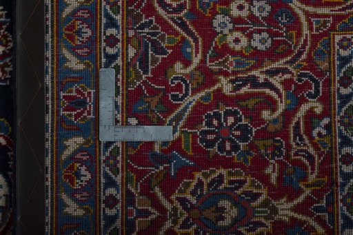 Backside of handmade 2000s Kashan rug showing knot structure and weave density