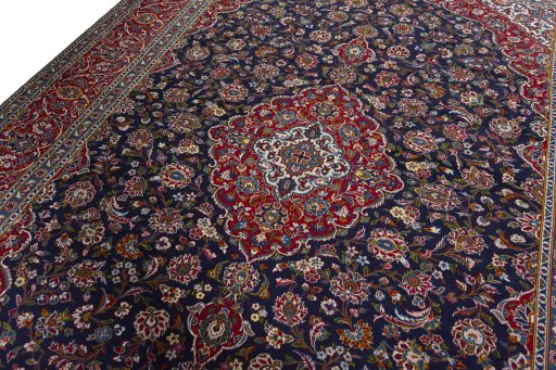 Backside of handmade 2000s Kashan rug showing knot structure and weave density