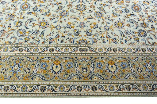 Corner detail of 2000s Kashan rug showing border pattern and Wool pile