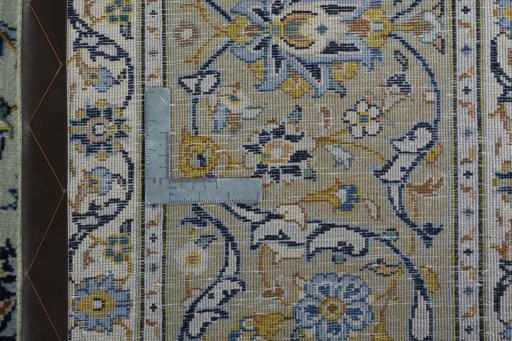 Backside of handmade 2000s Kashan rug showing knot structure and weave density