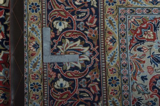 Backside of handmade New Kashan rug showing knot structure and weave density