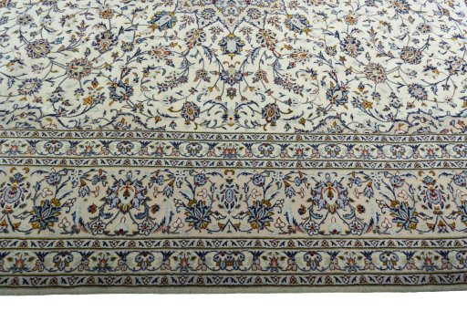 Corner detail of 2000s Kashan rug showing border pattern and Wool pile