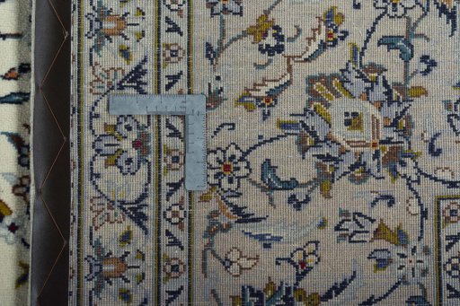 Backside of handmade 2000s Kashan rug showing knot structure and weave density