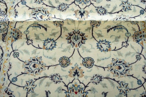 Corner detail of 2000s Kashan rug showing border pattern and Wool pile