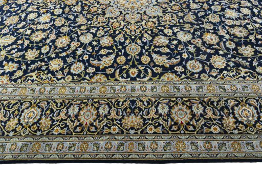 Corner detail of 2000s Kashan rug showing border pattern and Wool pile