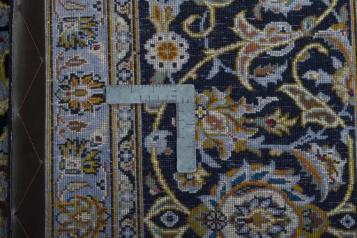 Backside of handmade 2000s Kashan rug showing knot structure and weave density