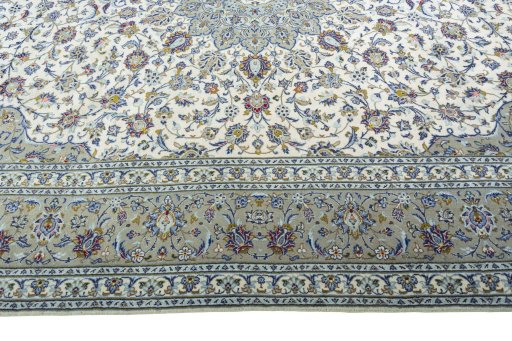 Corner detail of 2000s Kashan rug showing border pattern and Wool pile
