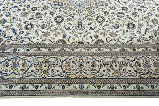 Corner detail of 2000s Kashan rug showing border pattern and Wool pile