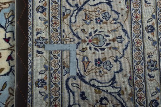Backside of handmade 2000s Kashan rug showing knot structure and weave density