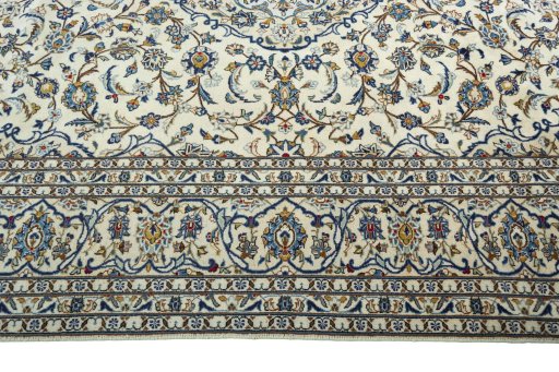 Corner detail of 2000s Kashan rug showing border pattern and Wool pile