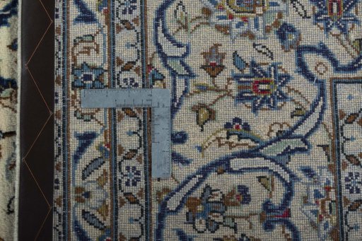 Backside of handmade 2000s Kashan rug showing knot structure and weave density