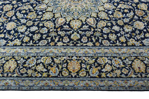 Corner detail of 2000s Kashan rug showing border pattern and Wool pile