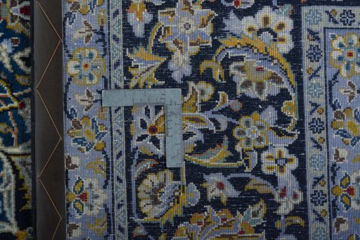 Backside of handmade 2000s Kashan rug showing knot structure and weave density