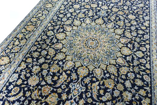 Backside of handmade 2000s Kashan rug showing knot structure and weave density