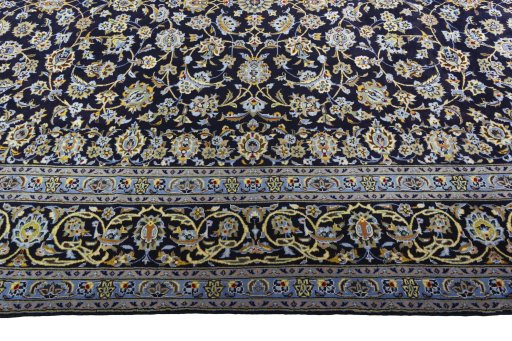 Corner detail of 2000s Kashan rug showing border pattern and Wool pile