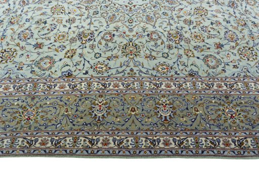 Corner detail of 2000s Kashan rug showing border pattern and Wool pile