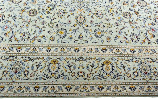 Corner detail of 2000s Kashan rug showing border pattern and Wool pile