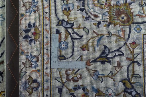 Backside of handmade 2000s Kashan rug showing knot structure and weave density