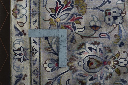 Backside of handmade 2000s Kashan rug showing knot structure and weave density