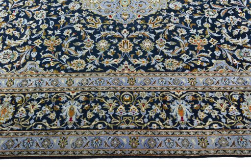 Corner detail of 2000s Kashan rug showing border pattern and Wool pile