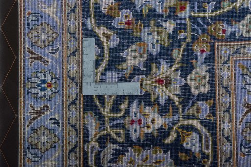 Backside of handmade 2000s Kashan rug showing knot structure and weave density