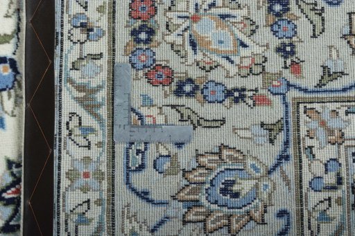 Backside of handmade New Kashan rug showing knot structure and weave density