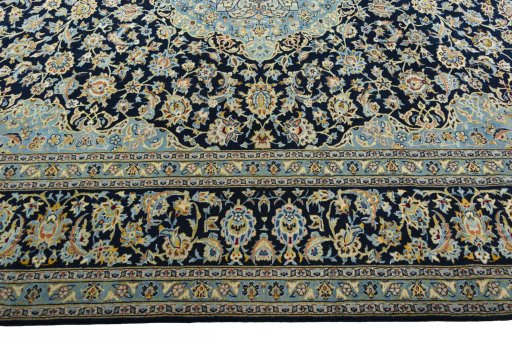 Corner detail of 2000s Kashan rug showing border pattern and Wool pile
