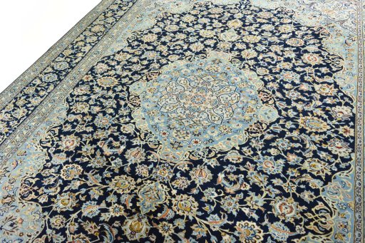 Backside of handmade 2000s Kashan rug showing knot structure and weave density