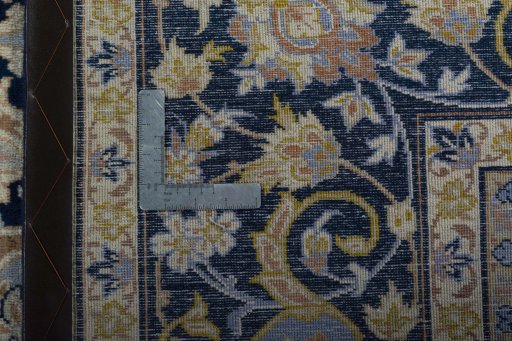 Backside of handmade 2000s Kashan rug showing knot structure and weave density
