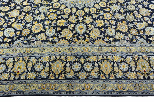 Corner detail of 2000s Kashan rug showing border pattern and Wool pile