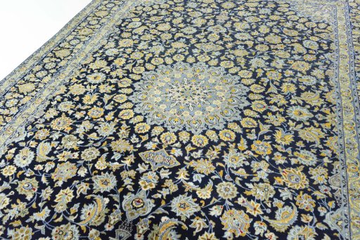 Backside of handmade 2000s Kashan rug showing knot structure and weave density