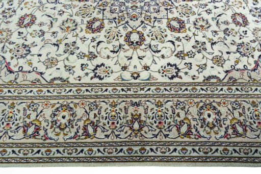 Corner detail of 2000s Kashan rug showing border pattern and Wool pile