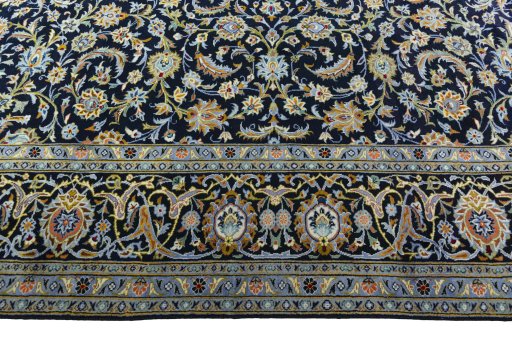 Corner detail of 2000s Kashan rug showing border pattern and Wool pile
