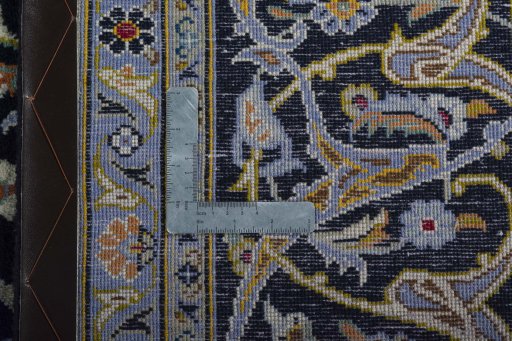Backside of handmade 2000s Kashan rug showing knot structure and weave density