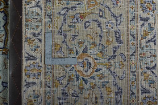 Backside of handmade 2000s Kashan rug showing knot structure and weave density