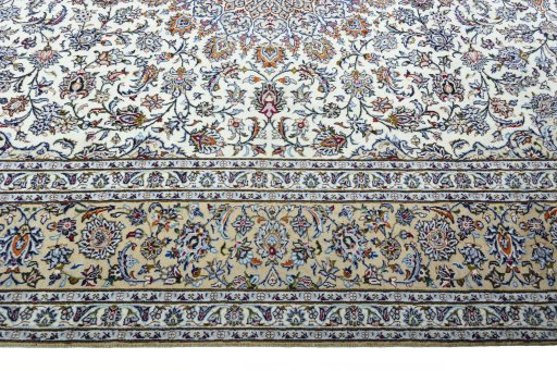 Corner detail of 2000s Kashan rug showing border pattern and Wool pile