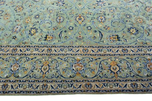 Corner detail of 2000s Kashan rug showing border pattern and Wool pile