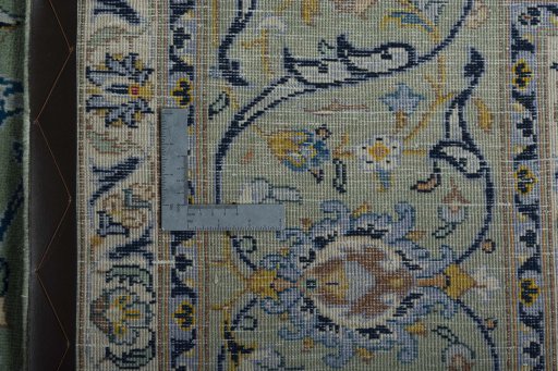 Backside of handmade 2000s Kashan rug showing knot structure and weave density
