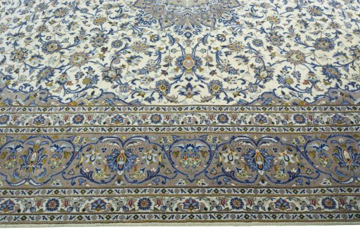 Corner detail of 2000s Kashan rug showing border pattern and Cork pile